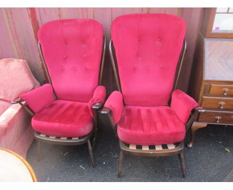 A pair of mid 20th century, dark Ercol stick back armchairs