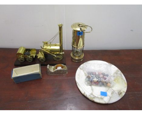 A mixed lot to include a marble solitaire board with stone marbles, a brass miners lamp, a brass model of a train and a silve