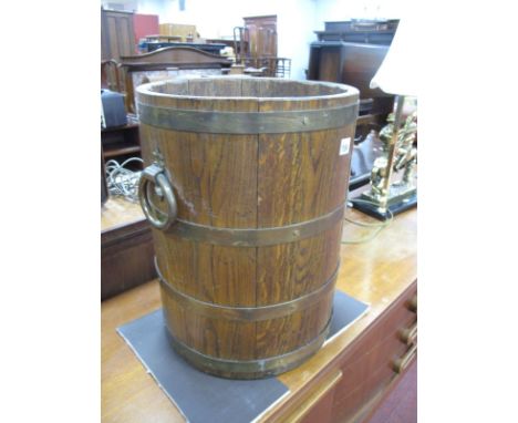 An Oak Brass bound Stick Stand, with twin brass handles.