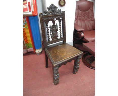 A XIX Century Carved Oak Hall Chair, with a carved top rail with bird decoration, bobbin supports, carved splat, solid seat, 