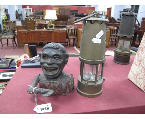 An Eccles Miners Lamp, a XIX Century cast iron jolly money box. (2)
