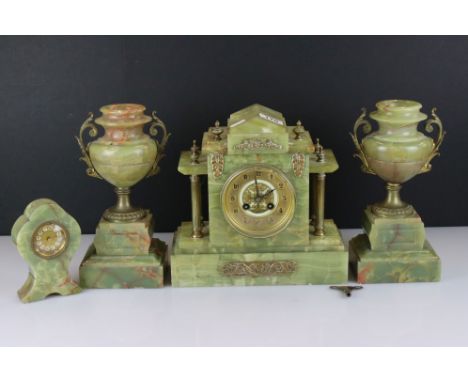 A 19th century green marble mantle clock together with a pair of matching urn garnitures and a smaller clock. 