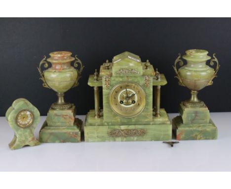 A 19th century green marble mantle clock together with a pair of matching urn garnitures and a smaller clock. 