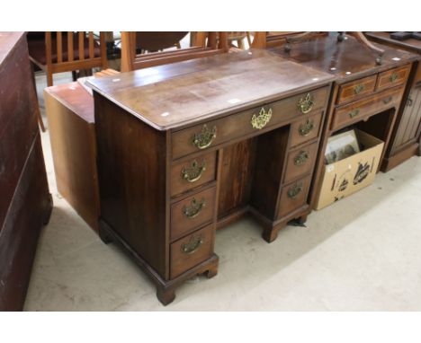 George III Mahogany Kneehole Writing Desk with an arrangement of seven drawers, the central kneehole with panel cupboard door