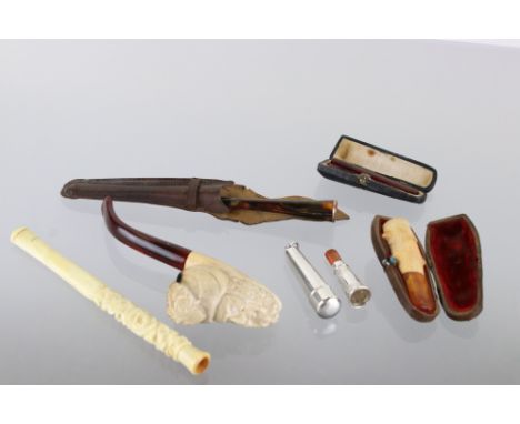 Collection of cheroot holders to include a hallmarked silver example in original silver case, cased amber cheroot holder, tor