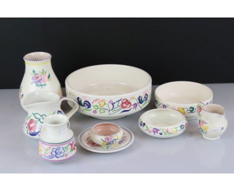 Nine pieces of Poole pottery to include bowls, vases, jugs..etc. 
