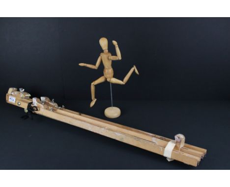 A large artist easel together with an artists mannequin and a wand rest stick. 