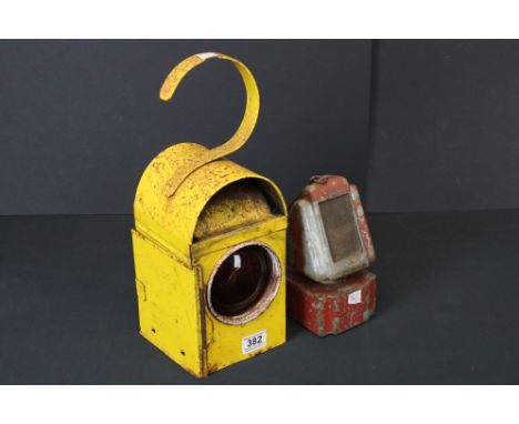 A vintage yellow road lamp together with a small metal heater light. 