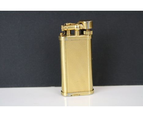 A gold plated Dunhill pocket cigarette lighter. 