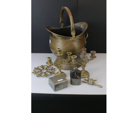 A small collection of mixed brassware to include a coal bucket, candlesticks and a door knocker in the form of a fox. 