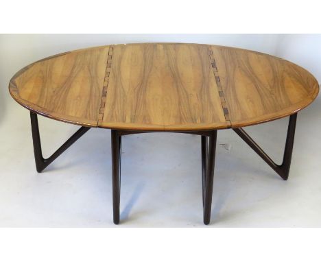 Kurt Ostervis Danish rosewood drop-leaf dining table, raised on pointed column supports, height 72cm, length 130cm CONDITION 