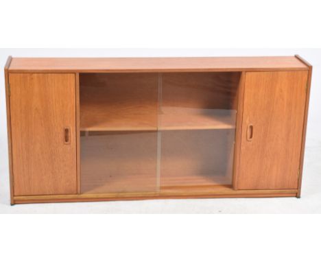 A 1960's/1970's teak cabinetThe two central sliding glazed doors enclosing a single shelf and flanked by two cupboard doors, 