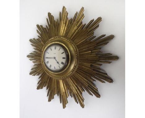 An Art Deco gilt wood eight day sunburst wall clock The circular dial with Roman numerals, diameter 38cm  GOOD CONDITIONLooks