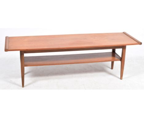 A 1960's/1970's teak coffee tableThe swelling rectangular top raised upon tapering legs of square section with a rectangular 