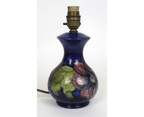 A Moorcroft table lamp of baluster formDecorated in the Clematis pattern on a blue ground, impressed marks and paper label to