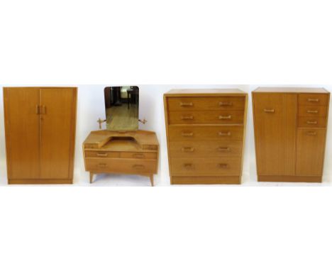 A Mid Century G-Plan teak four piece bedroom suiteComprising twin door wardrobe, width 125cm, mirrored back dressing table wi