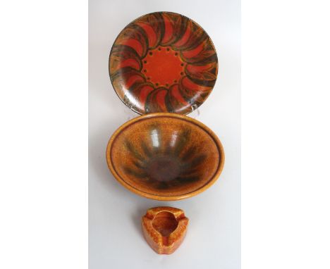 Three pieces of Pilkingtons Royal Lancastrian Orange VermillionTo include dish with black painted scrolling decoration, by Gw