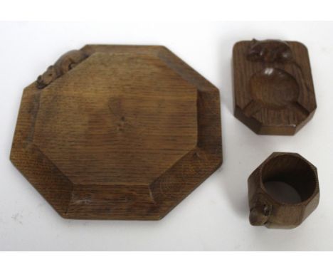 Three pieces of Robert Mouseman Thompson of Kilburn adzed oak To include cheese board of octagonal form, diameter 19cm, ashtr