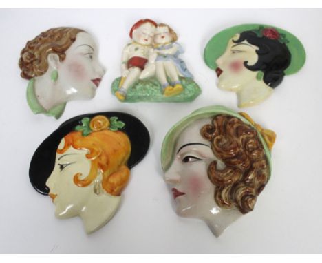 Five Art Deco ceramic wall plaques To include Crown Devon Fieldings example depicting two seated children, length 15cm, J H C