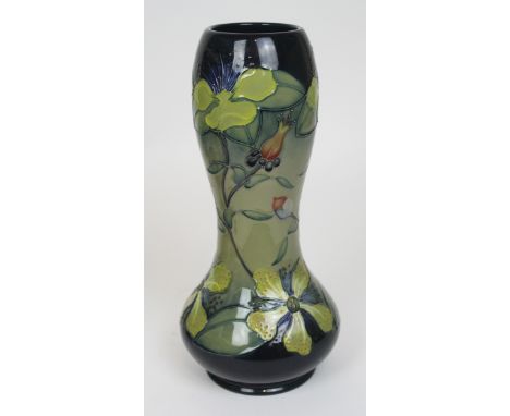A Moorcroft Double Gourd vaseHaving floral decoration on a blue and jade ground, impressed marks to base, height 29cm 