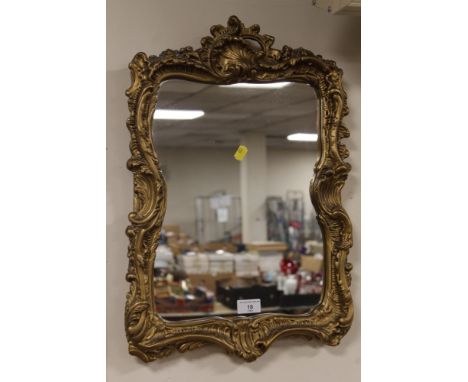 A GILT FRAMED WALL MIRROR