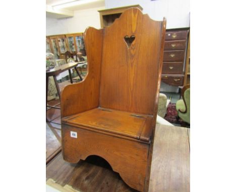 ANTIQUE ELM CHILD'S ROCKING CHAIR, rising seat encloses a commode base, 70cm height 