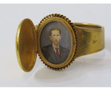 UNUSUAL HINGED LOCKET STYLE PORTRAIT BANGLE, in yellow metal, tests possibly high carat  Lot 88: The overall bangle is sound,