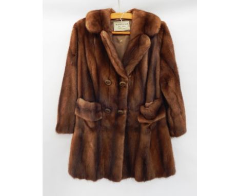 A 1960's double-breasted mink three-quarter length coat with pockets, a half belt and buttons from Marshalls Fine Furs, Wilms