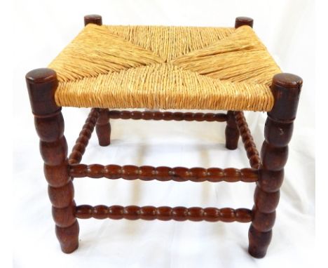 Ernest Gimson yew rush-seated stool made by Edward Gardiner on bobbin turned supports and cross stretchers 

This stool was c