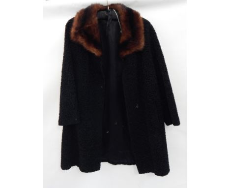 An vintage black astrakhan coat with a musquash collar  Live Bidding: If you would like a condition report on this lot, pleas