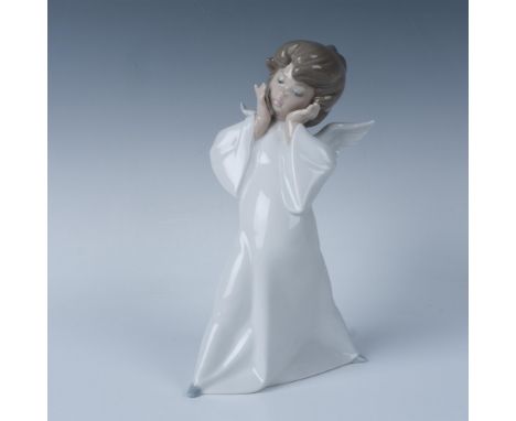 Glossy figure dressed in a white gown with head tilted in confusion. Lladro backstamp. This item has its original box: 7.25"L