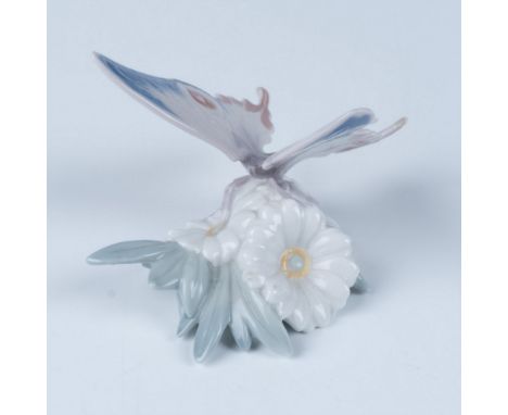 A glossy figure of a beautiful butterfly landing on flowers. This item has its original box, measuring 7.25"L x 5.5"W x 4.75"