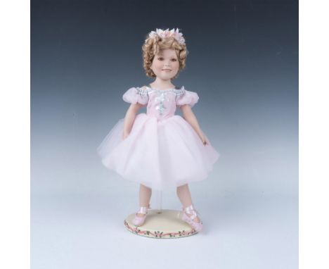 Hand painted adorable ballerina dressed in hand sewn pink tutu with matching slippers. Her famous curly hair is adorned with 