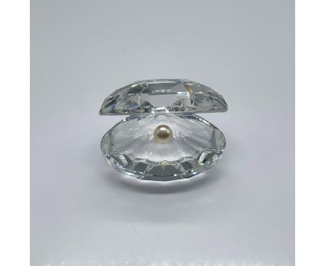 Part of the Aquatic Worlds theme group. A clear faceted crystal open oyster with a white crystal pearl. Swarovski swan mark. 