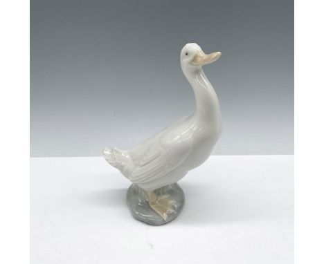 Glossy white figure with tan beak and feet, head up in walking stance. Nao by Lladro backstamp. Issued: 1978Dimensions: 4.25"