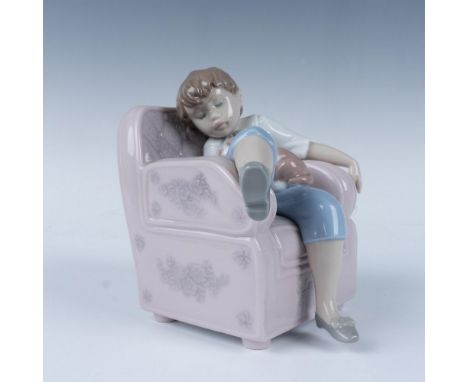 A glossy figure beautifully capturing a serene and tender moment of rest. The piece features a young child peacefully napping