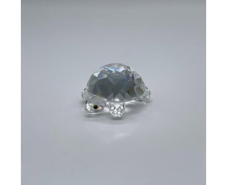 Part of the In The Secret Garden collection. A clear crystal reptile with peridot-green colored eyes. Swarovski swan mark. Th
