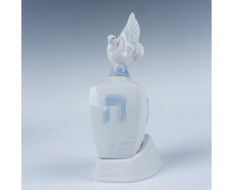 A glossy figure featuring a finely crafted dreidel adorned with a delicate dove perched on top. The dreidel, a traditional sp