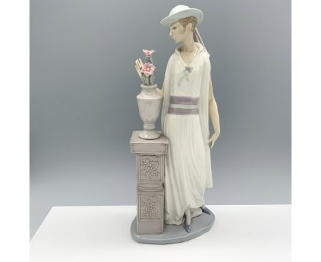 Glossy figure of a young woman very interested in a flower set atop a decorative pillar. Lladro backstamp. Artist: Vincente M