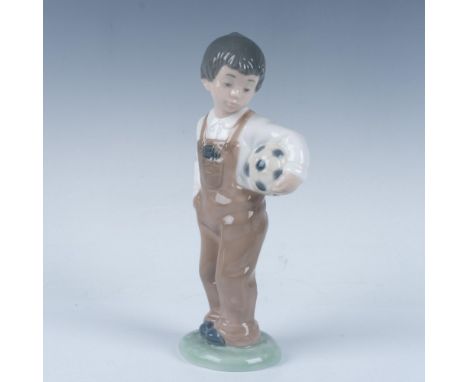 A glossy figure of an adorable boy holding a soccer ball. This item has its original box, measuring 10"L x 5.25"W x 4.75"H. N