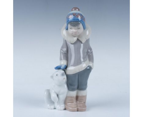 A glossy porcelain figurine beautifully captures an adorable young Inuit child with his beloved animal companion. Lladro back