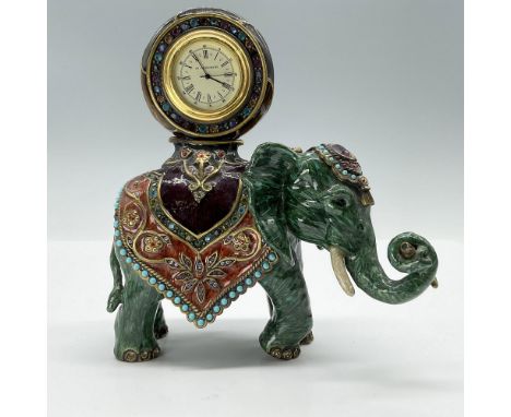 This is a gorgeous greenish-blue swirled figural elephant with a crystal encrusted clock on its back. This item has its origi