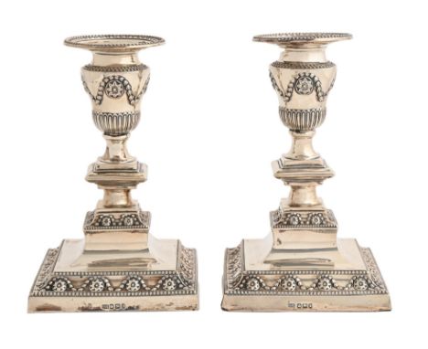 A pair of Victorian silver dwarf candlesticks,&nbsp; in neo classical style, on beaded square foot, nozzles, 17cm h, by Harri