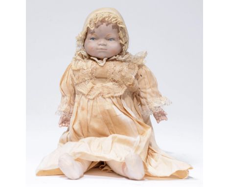 A Continental character bebe doll, late 19th c, the bisque shoulder-head with moulded hair on padded body with bisque forearm
