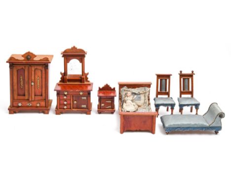 A suite of German stained softwood doll's house furniture, late 19th c, comprising wardrobe, bed, dressing chest, pot cupboar