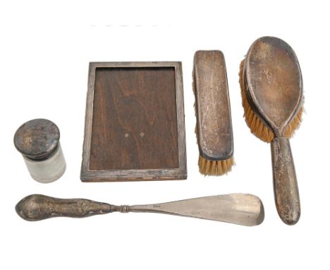 A George V silver photograph frame,&nbsp;engine turned, 16.5 x 12cm, part marked, by Henry Matthews, a silver brush set, silv