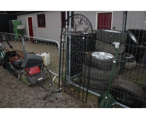 A wrought iron garden gate 