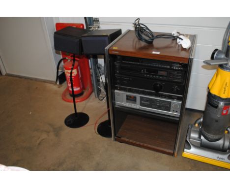 An Akai stereo cassette deck, a Technics amplifier, Technics tuner, technics compact disc player, contained in Hi-Fi cabinet 