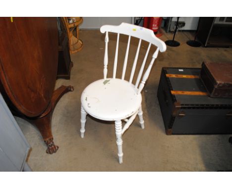 A white painted stick back chair
