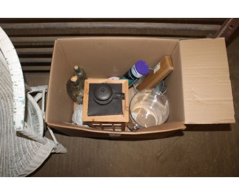 A box containing various candle holders, glass bottles and one other candle lantern